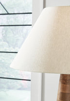 Cream fabric lamp shade over dark brown wooden base