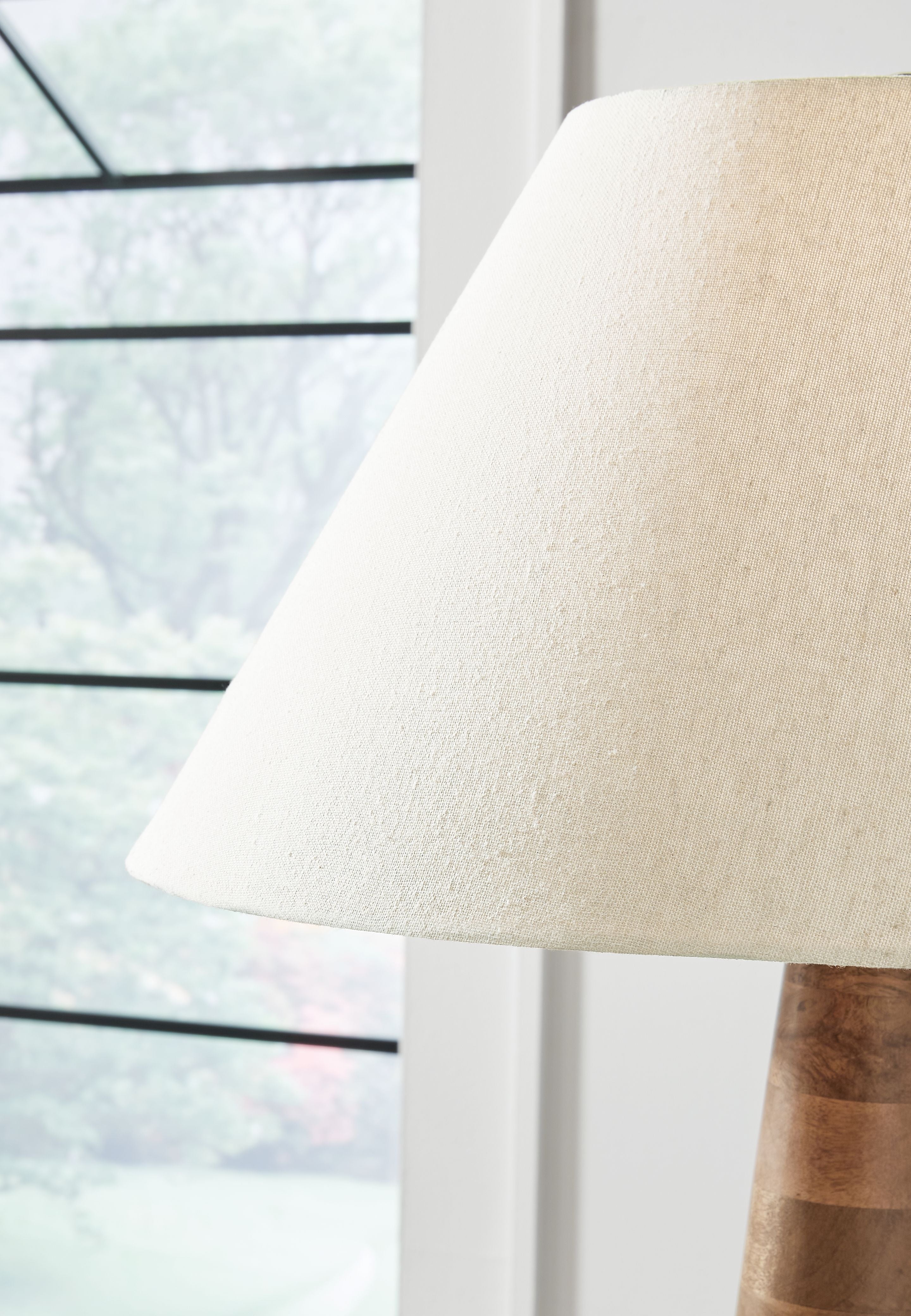 Cream fabric lamp shade over dark brown wooden base