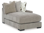 Pebble gray corner chaise with two throw pillows and fabric upholstery