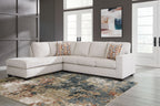 Light beige corner sectional sofa with patterned accent pillows and chaise section
