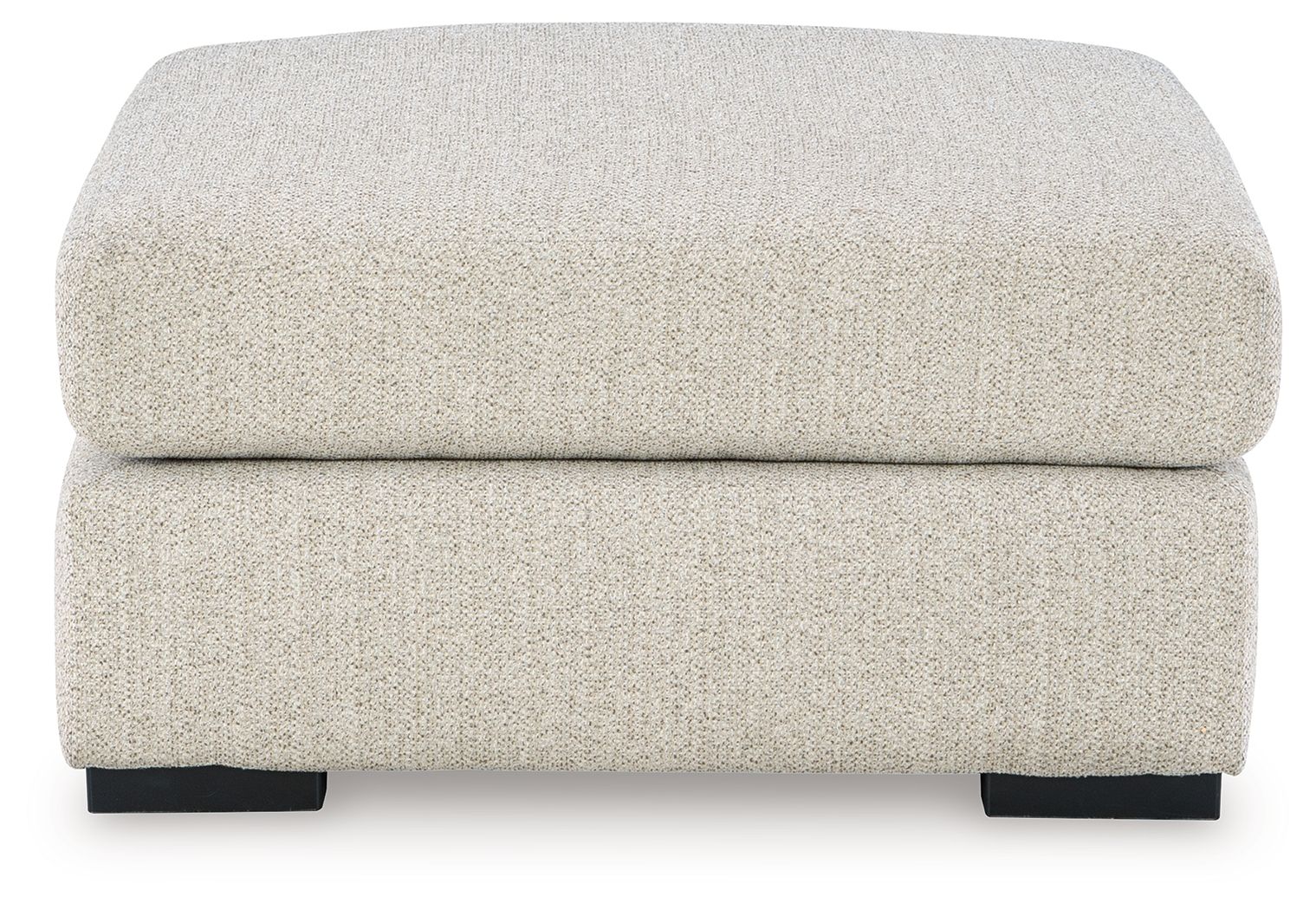 Oversized accent ottoman with rounded top cushion and dark block feet, pebble upholstery.