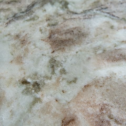 Marble-patterned tabletop surface detail with gray, white, and brown speckles