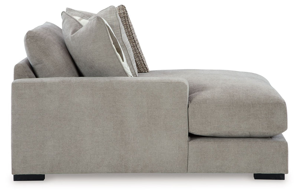 Pebble gray corner chaise with armrests, chaise cushion, and raised back pillows
