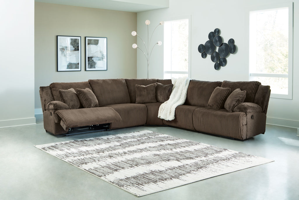 Brown ribbed reclining sectional sofa with chaise and backrest cushions