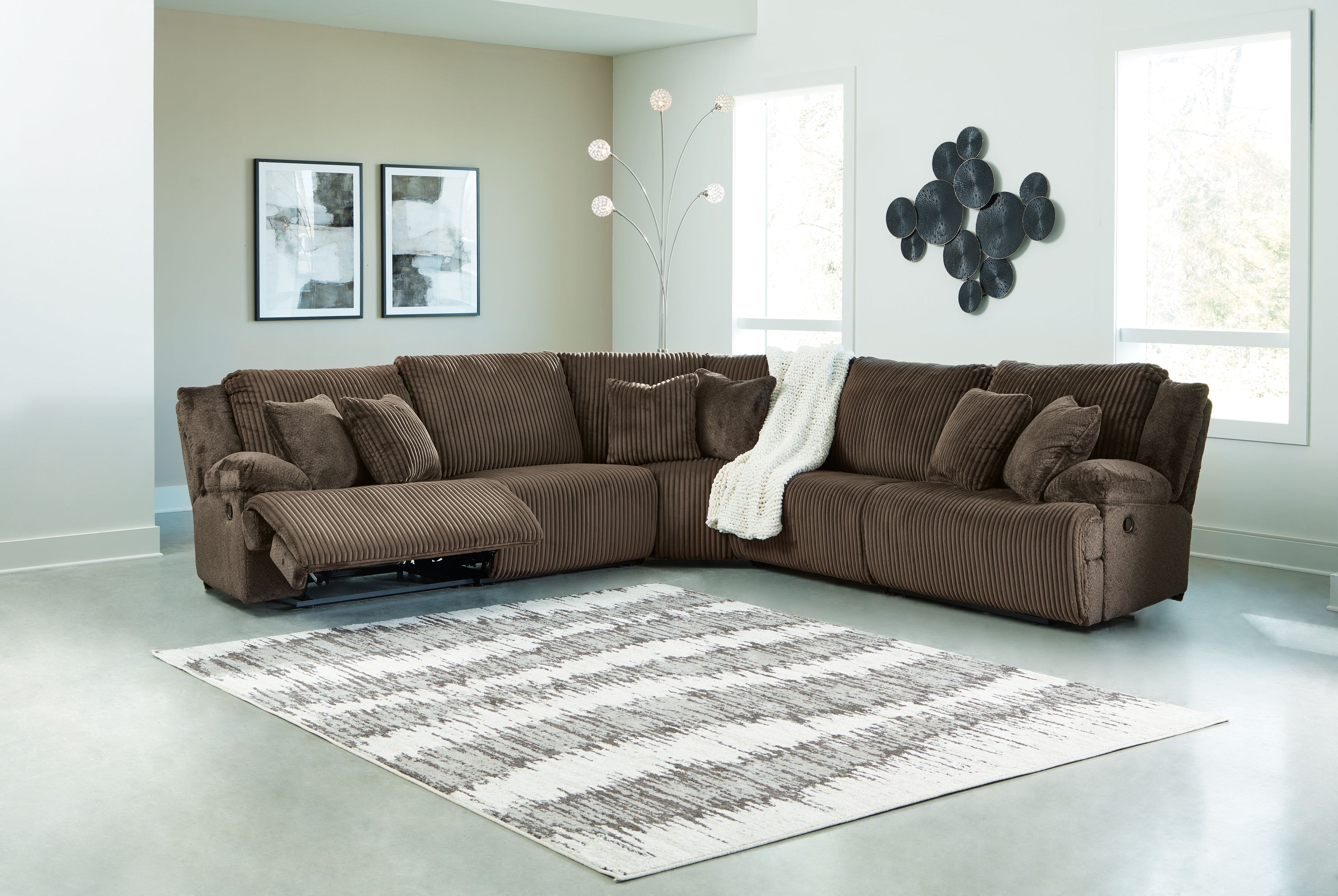 Brown ribbed reclining sectional sofa with chaise and backrest cushions