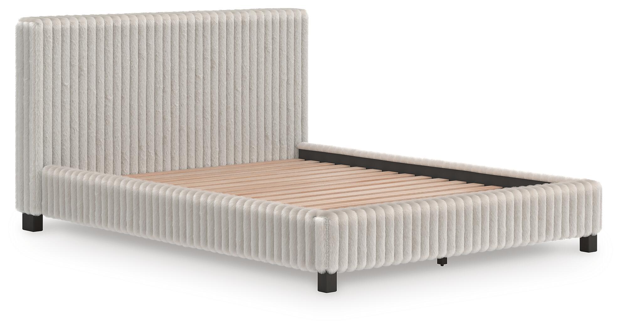White upholstered bed with vertical channel headboard, platform base, and beige mattress.
