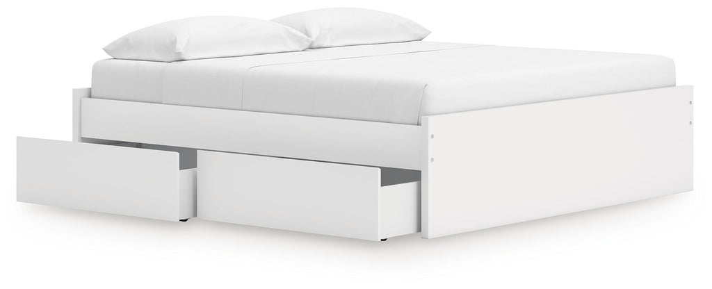 White platform bed with padded headboard and storage drawers