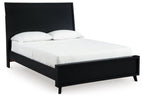 Black panel bed with upholstered headboard and footboard, white mattress and pillows
