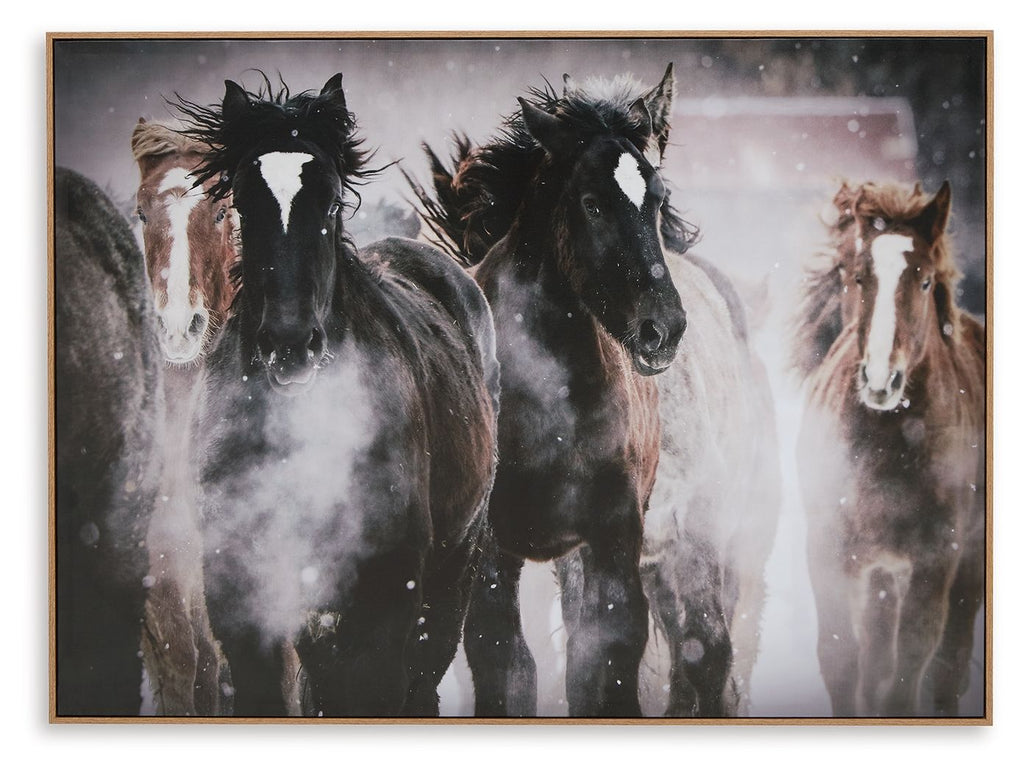 Framed wall art featuring three dark horses in a dusty scene
