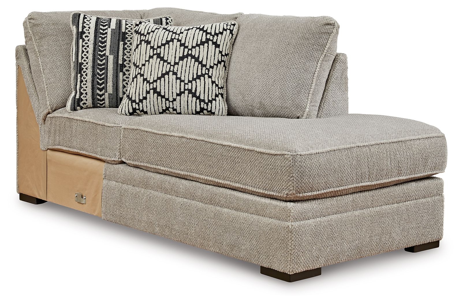 Corner chaise lounge with light gray upholstery, two patterned accent pillows, corner arm