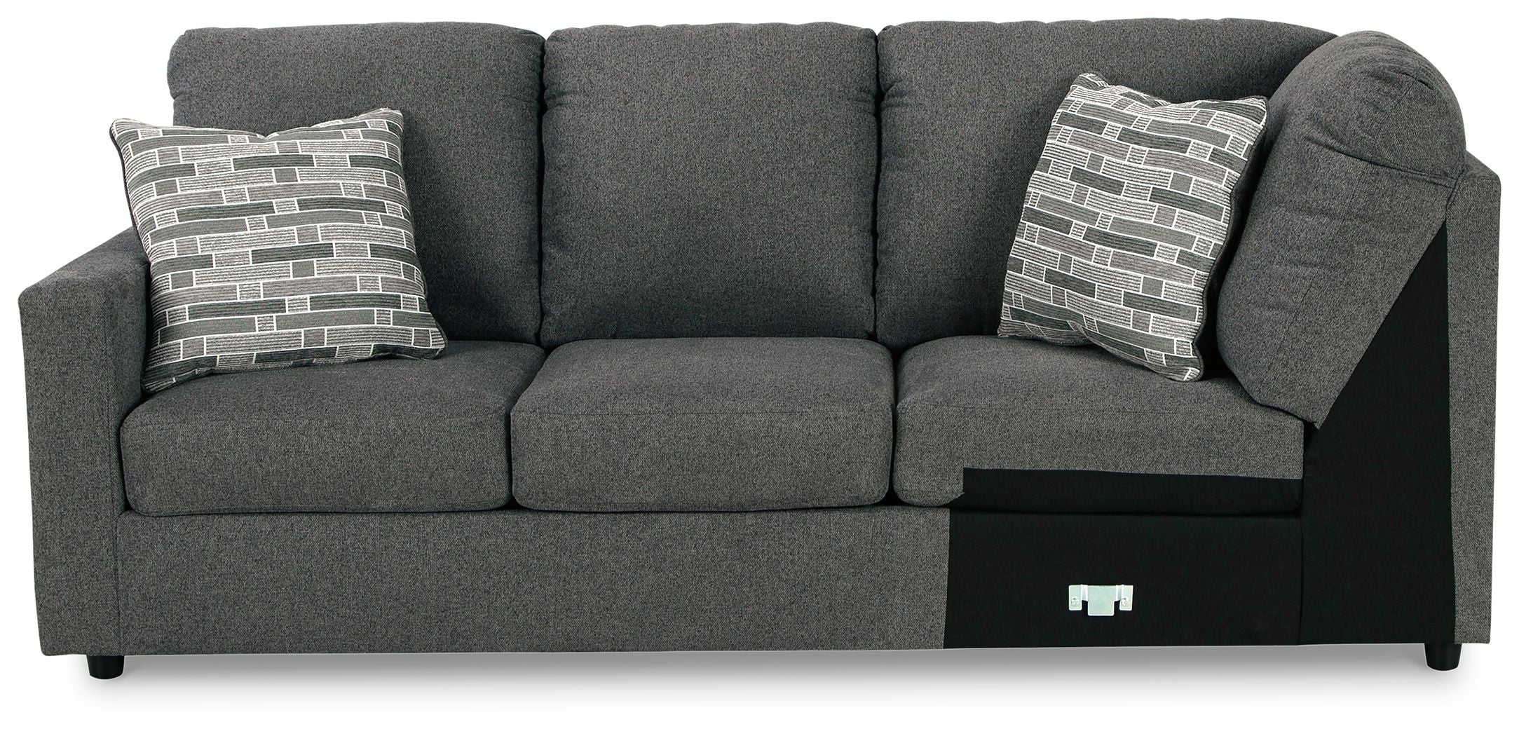 Dark gray wedge sofa with three seat cushions and two patterned throw pillows