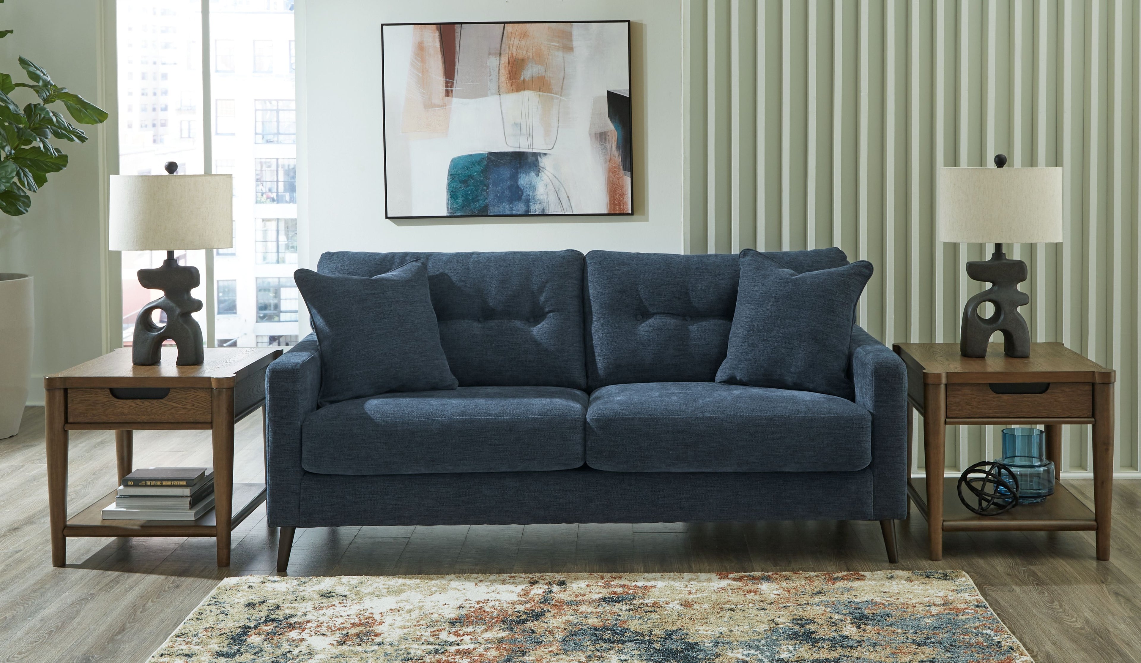 Navy blue sofa with square arms and four back cushions