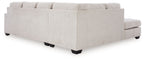 Light stone sectional sofa with upholstered cushions and block feet
