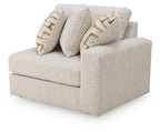 Light beige upholstered corner chair with wide arms and two patterned throw pillows