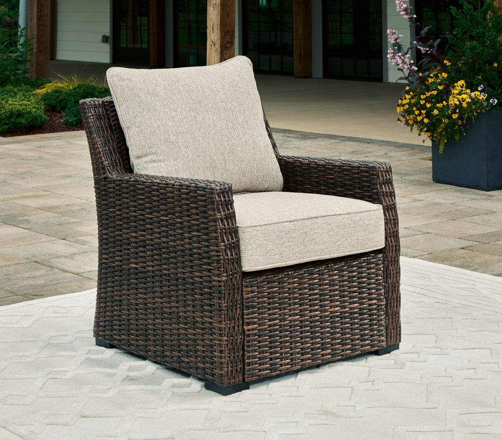 Brown woven lounge chair with light beige seat and back cushion