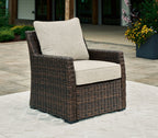 Brown woven lounge chair with light beige seat and back cushion
