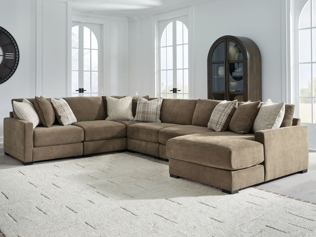 Coffee-brown sectional sofa with right chaise and multiple throw pillows in a living room setup