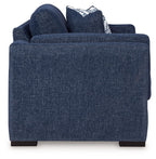 Blue loveseat sofa with rounded arms and white-and-blue striped throw pillows
