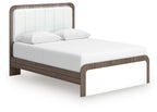 Upholstered bed with white headboard and padded sides, dark wood frame