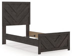 Panel bed with dark gray frame and chevron panel headboard, off-white mattress visible