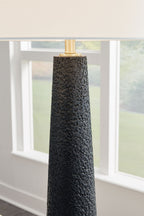 Black textured poly floor lamp body with brass socket and off-white shade