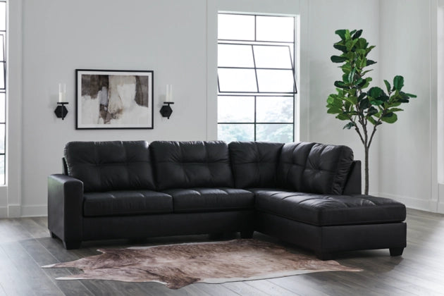 Dark charcoal sectional sofa with chaise corner and tufted back