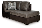Corner chaise chair in dark brown fabric with patterned throw pillow, right arm facing.
