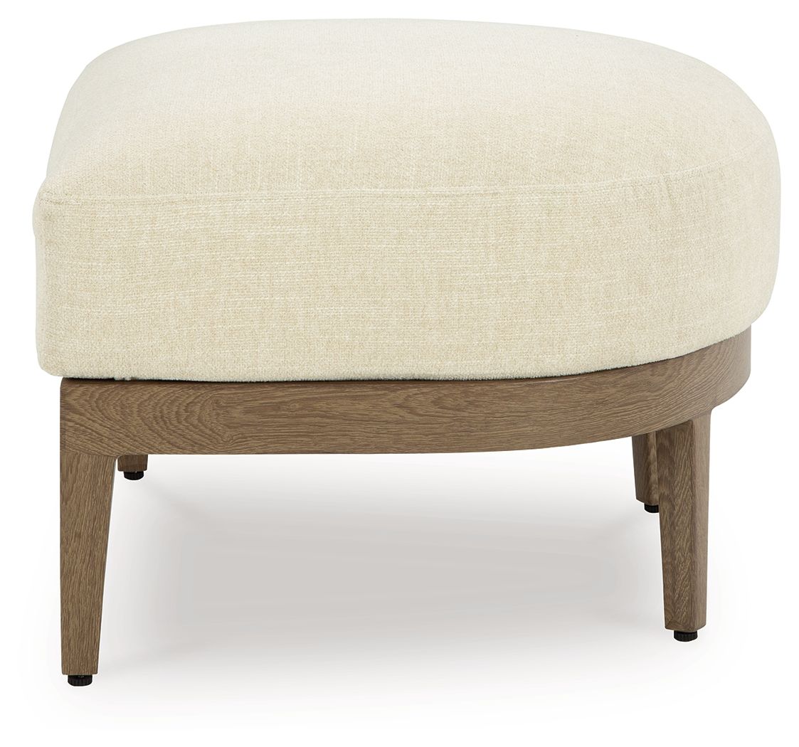 Beige-upholstered ottoman with dark brown wooden frame and tapered legs