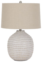 Beige ceramic table lamp with textured globe base and beige fabric drum shade