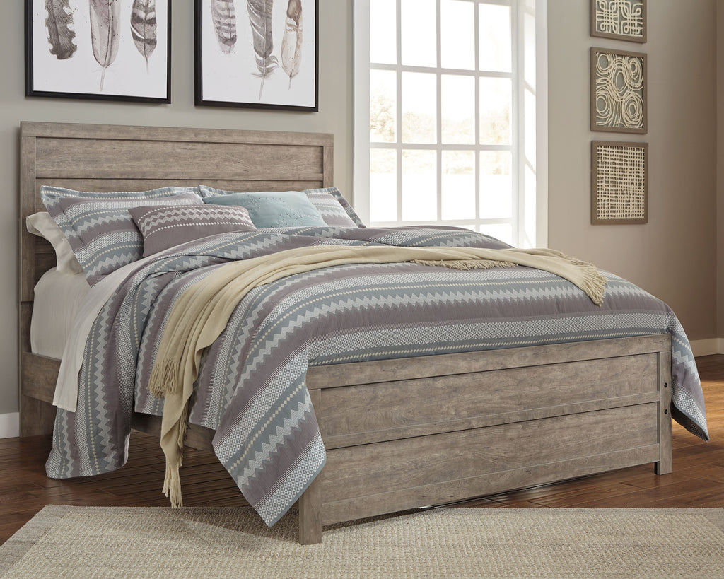Gray upholstered panel bed frame with tall headboard and storage drawers, with striped bedding