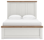 White panel storage bed with storage footboard, wood-trim headboard, and two pillows