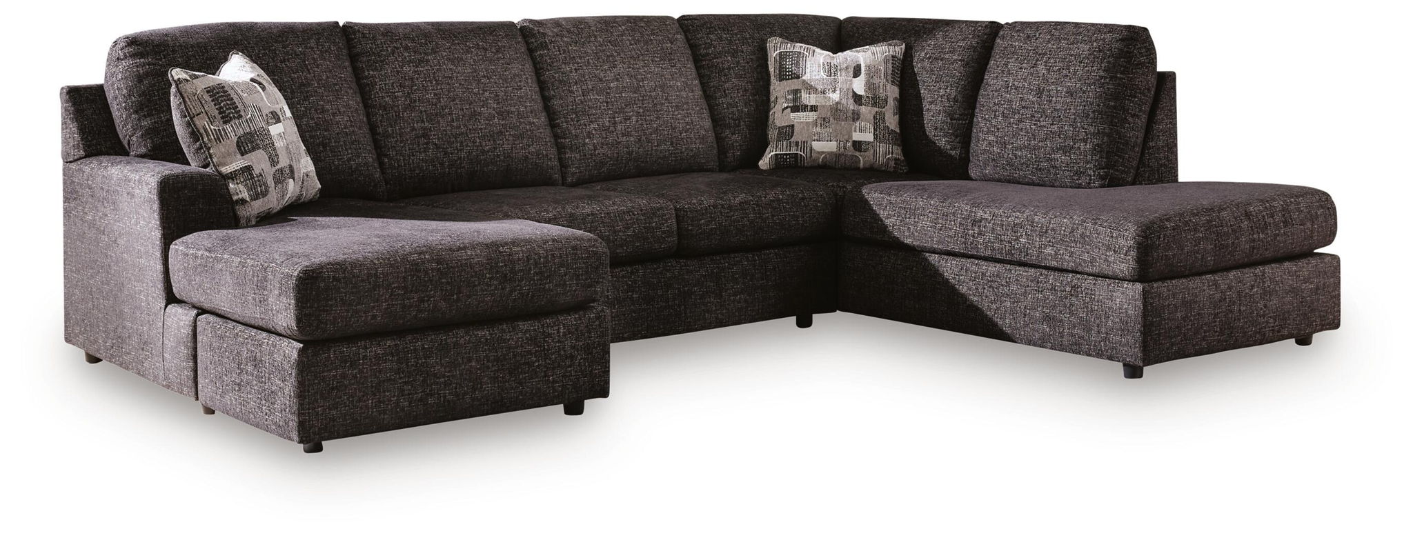Dark charcoal fabric sectional with chaise seating, low arms, and two back accent pillows