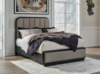 Dark gray upholstered panel bed with vertical headboard panels and low frame