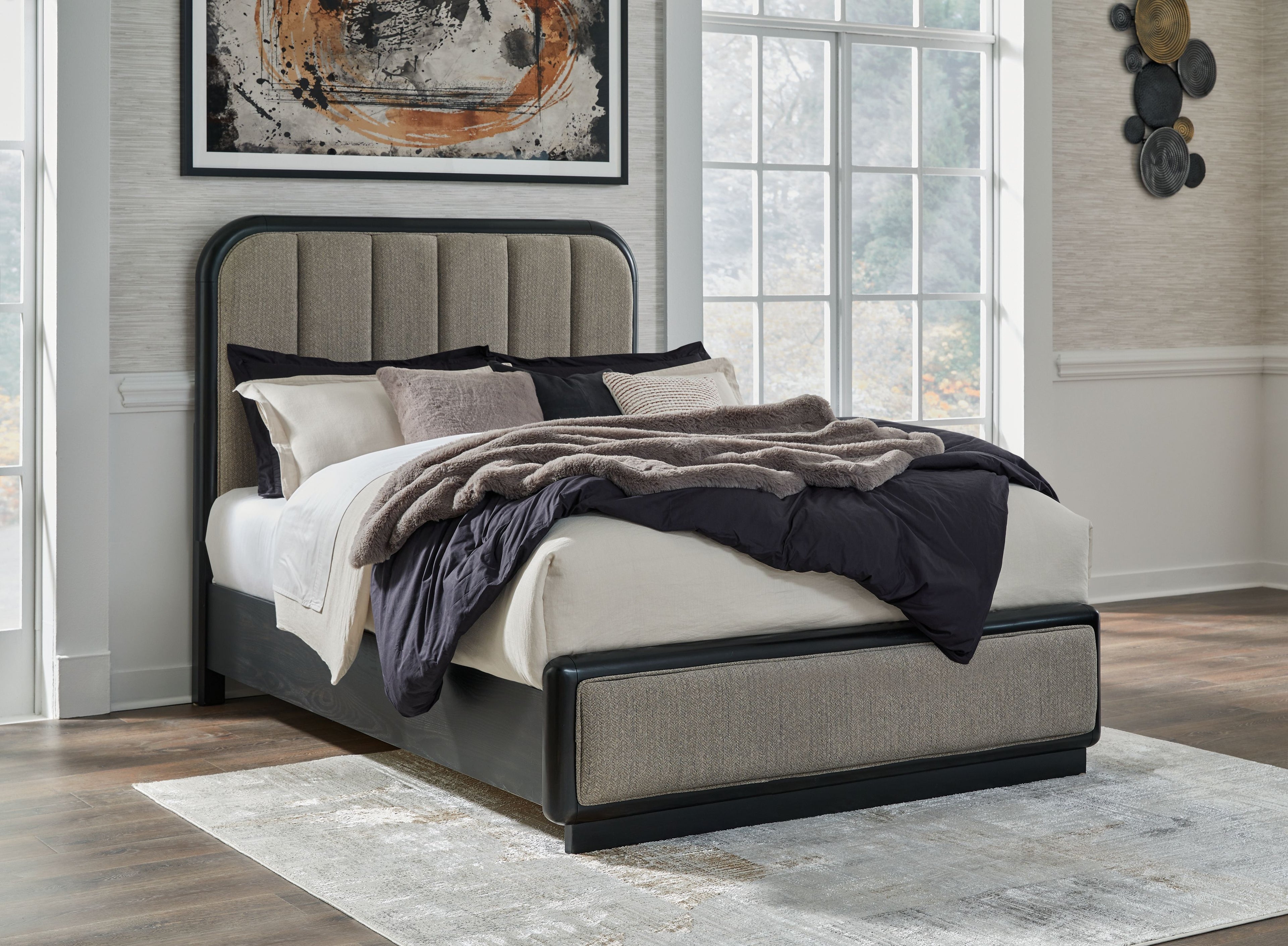 Dark gray upholstered panel bed with vertical headboard panels and low frame