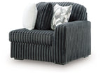 Gunmetal corduroy corner chair with dark side arm and patterned throw pillow