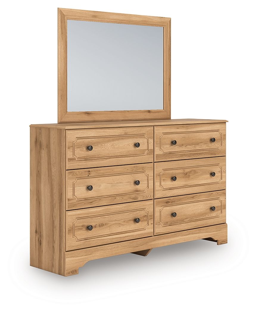 Aleaport dresser with light brown wood, mirror, and drawer fronts with round knobs