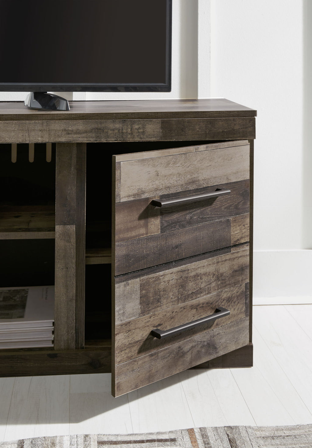 Entertainment center drawer unit in dark gray wood with metal bar handle