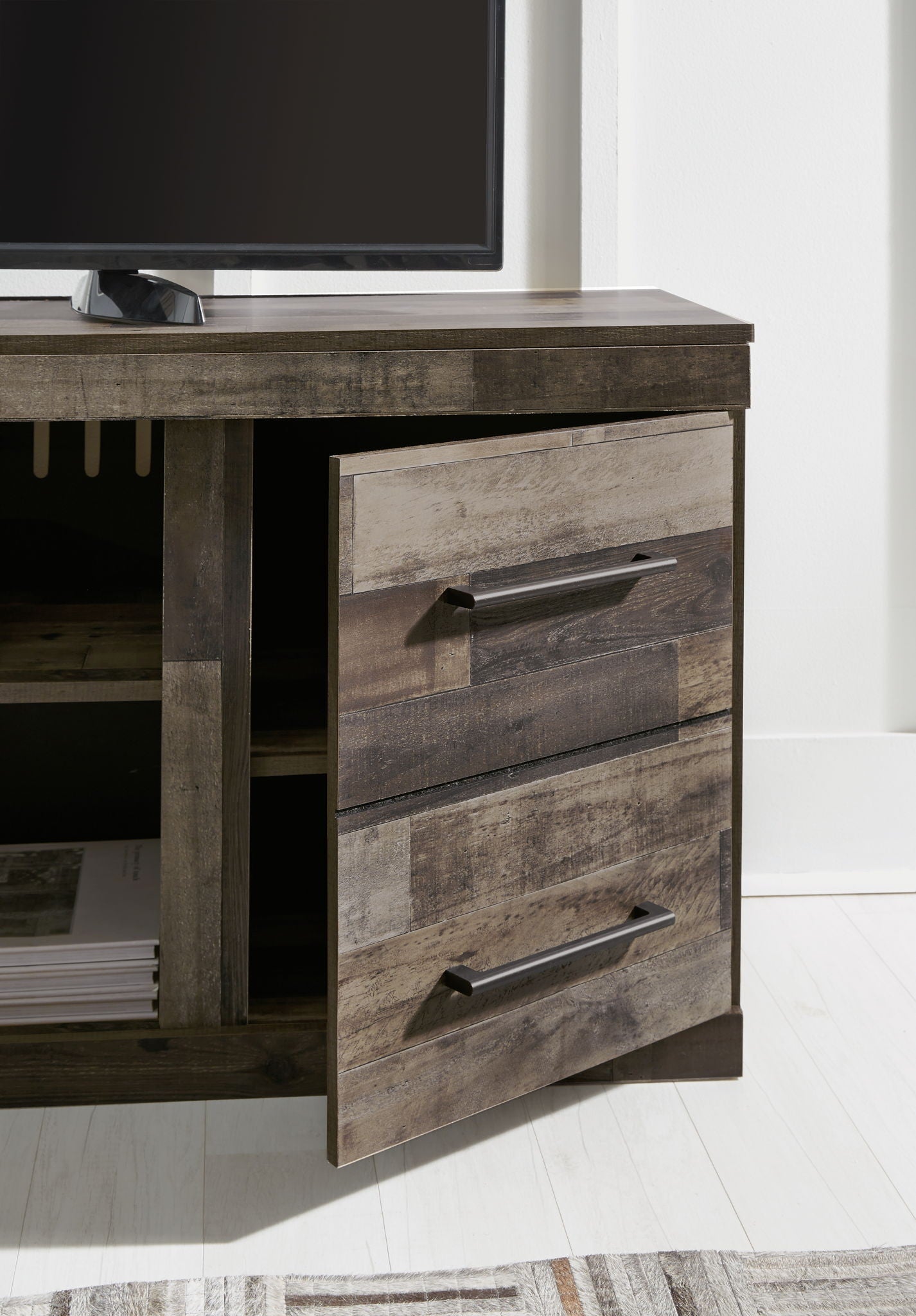 Entertainment center drawer unit in dark gray wood with metal bar handle