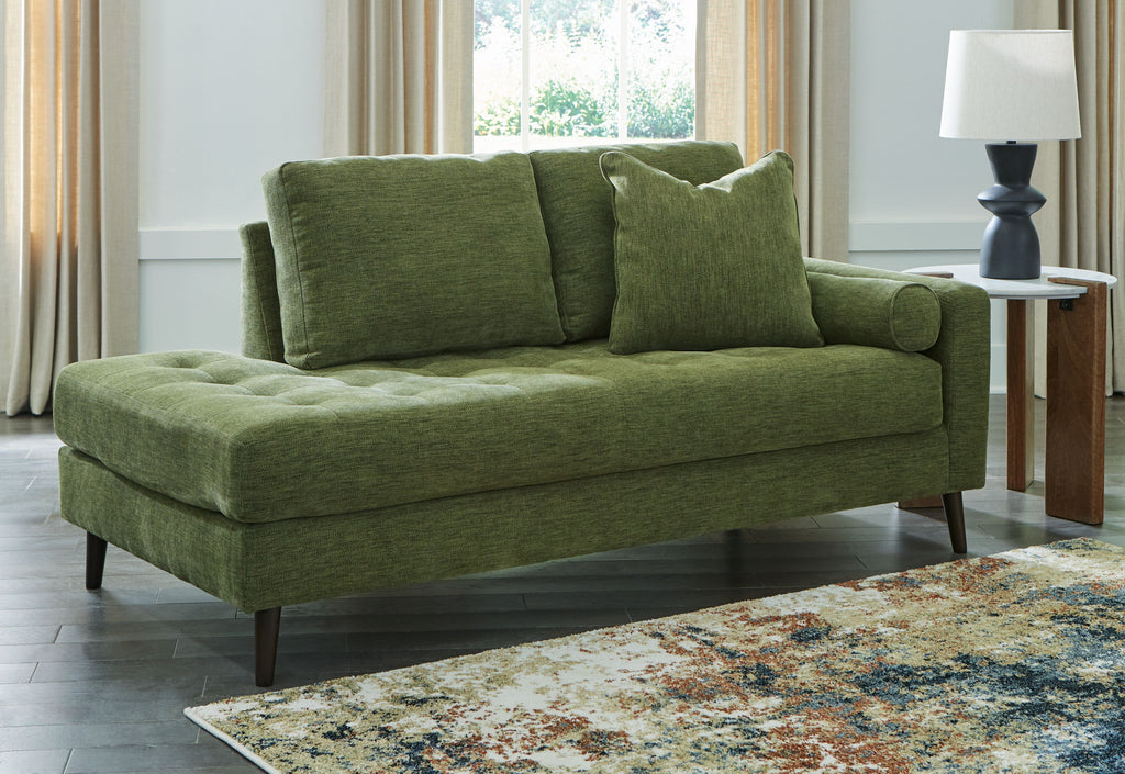 Green corner chaise sofa with tufted back cushions and dark tapered legs