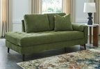 Green corner chaise sofa with tufted back cushions and dark tapered legs