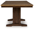 Rectangular counter-height extension table with brown wood top and pedestal base.