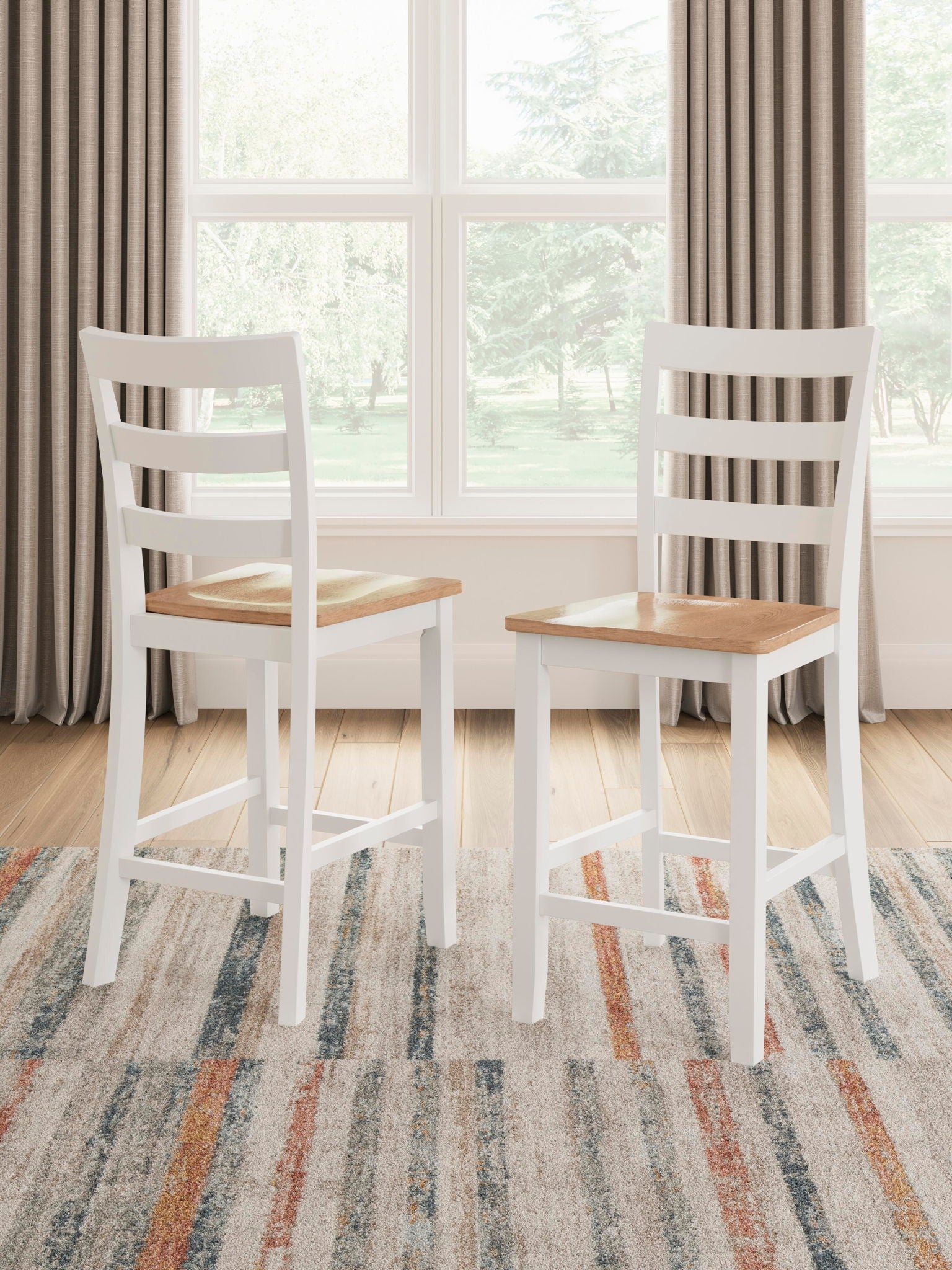 Two white barstools with slatted back and wooden seats, standing side by side