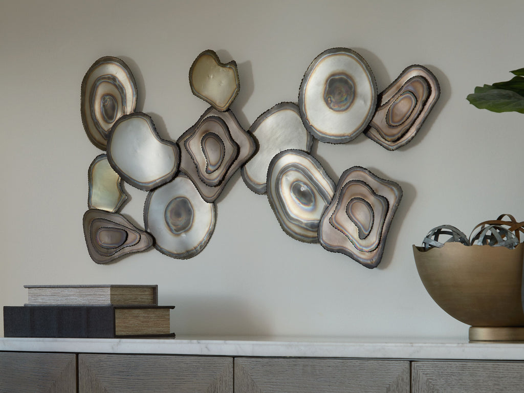 Multi-piece wall decor cluster of resin stone discs with concentric rings in cream and gray