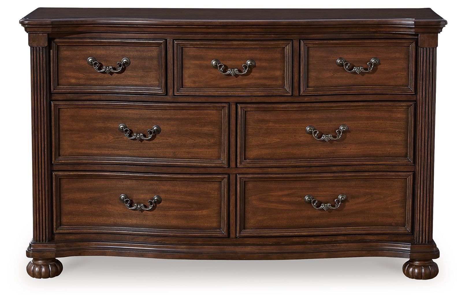 Brown wooden dresser with six drawers and arched metal pulls, thick legs and apron