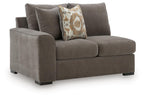 Dark gray fabric loveseat with square arms, short legs, and patterned throw pillow