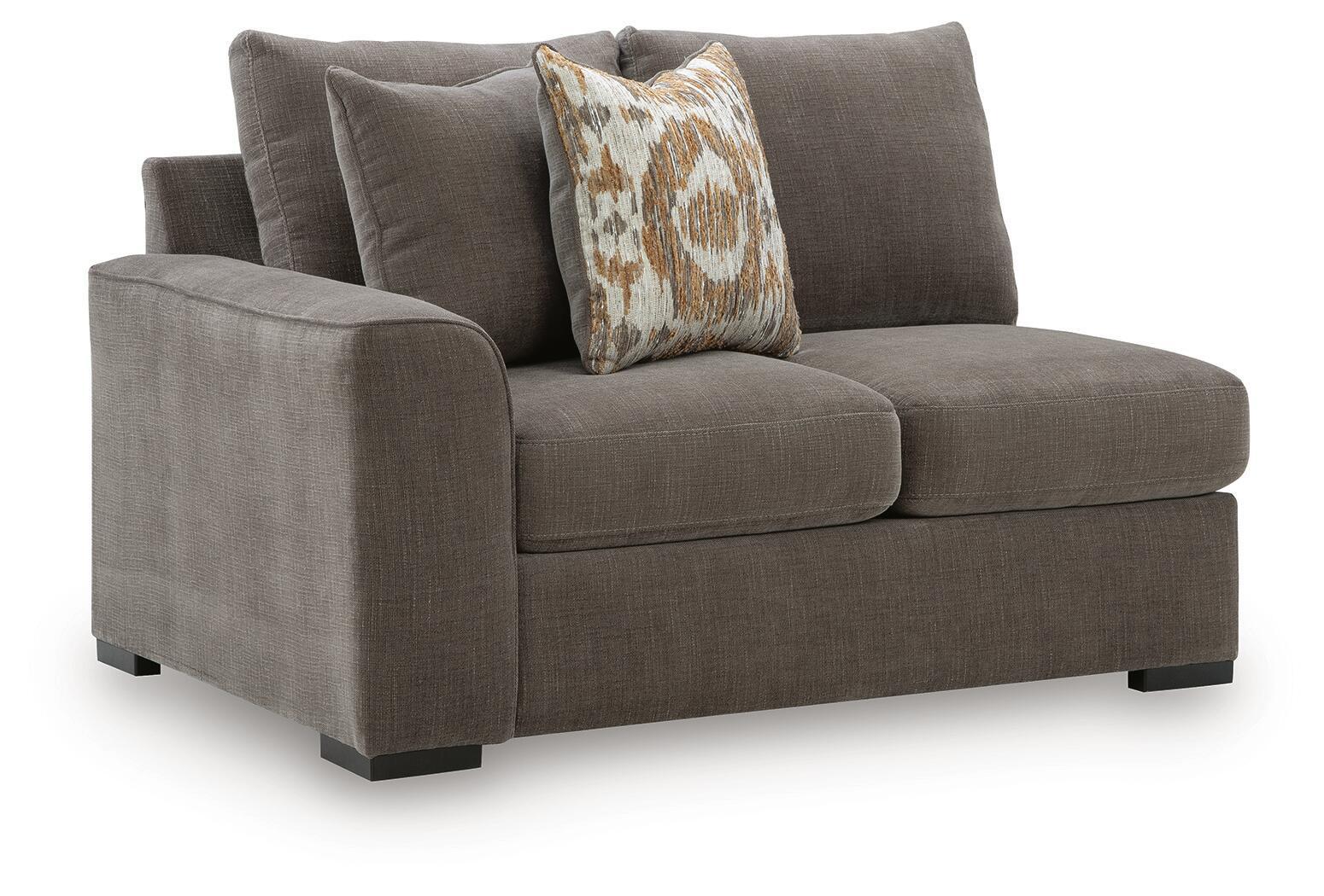 Dark gray fabric loveseat with square arms, short legs, and patterned throw pillow