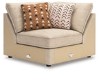 Sand beige fabric wedge chair with two patterned throw pillows