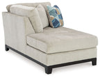 Stone corner chaise with left-facing seat, square armrest, geometric pillow, dark wooden legs