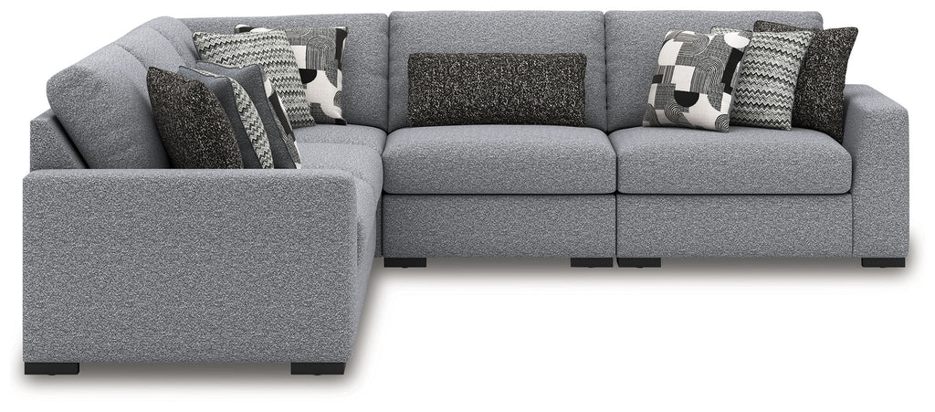 Gray sectional sofa with chaise seating and patterned throw pillows