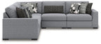Gray sectional sofa with chaise seating and patterned throw pillows